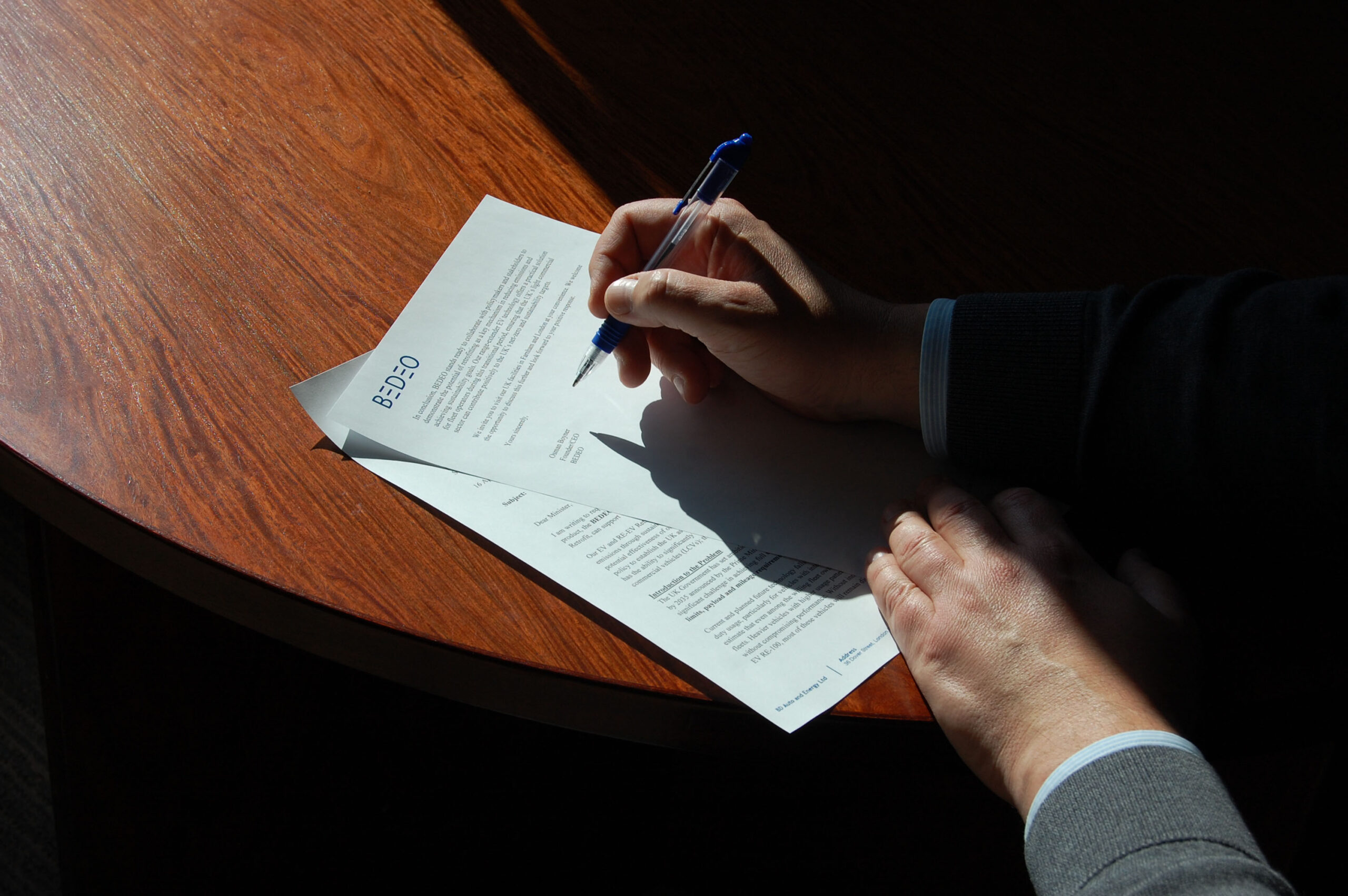 BEDEO Owner, Osman Boyner, signing a letter to a Government minister